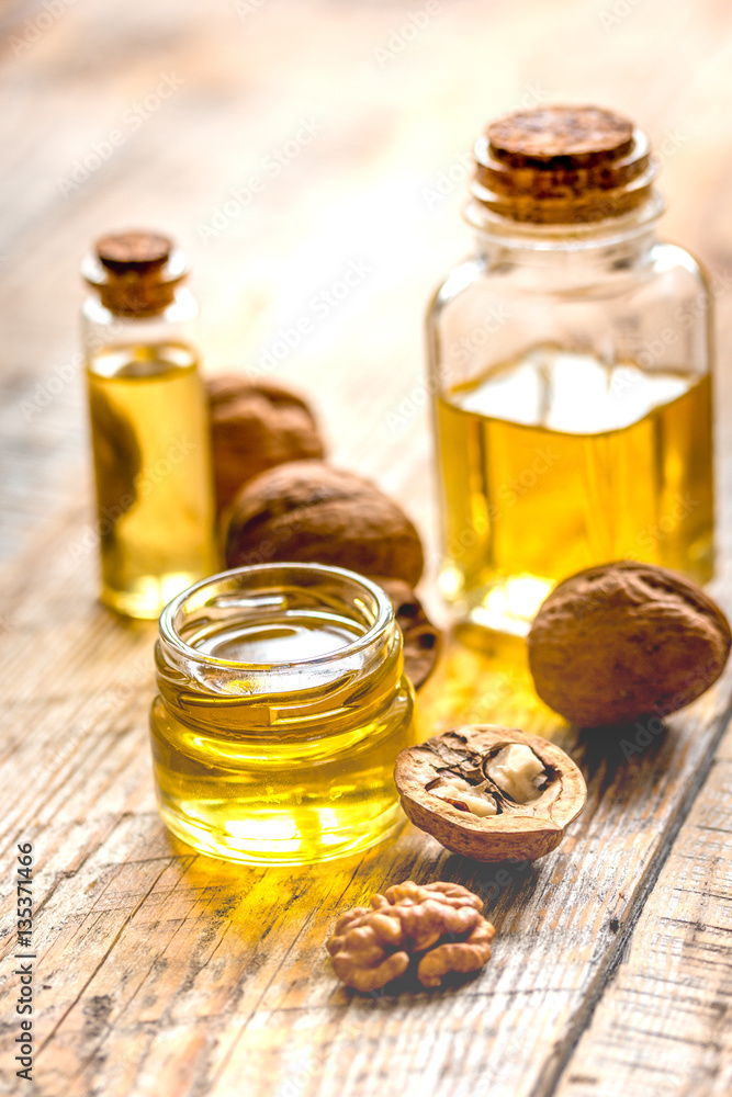 cosmetic and therapeutic walnut oil on wooden background