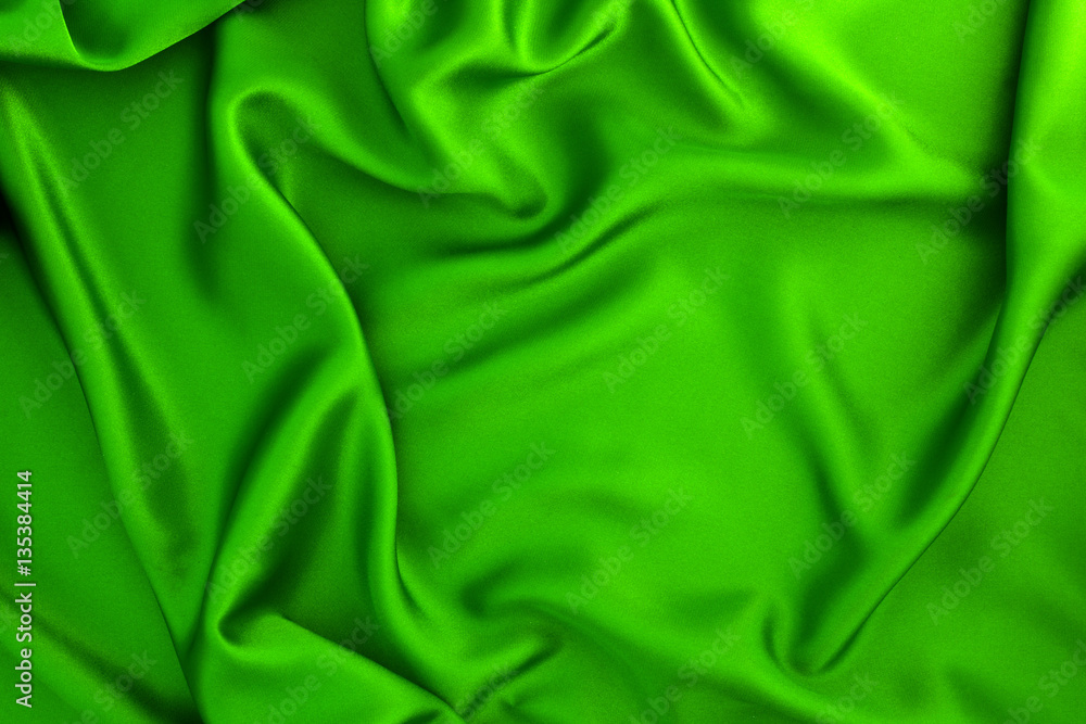 Close up wave green silk or satin fabric background