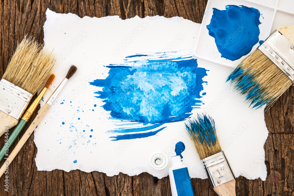 Art brush and blue watercolor painted with white paper art  on w