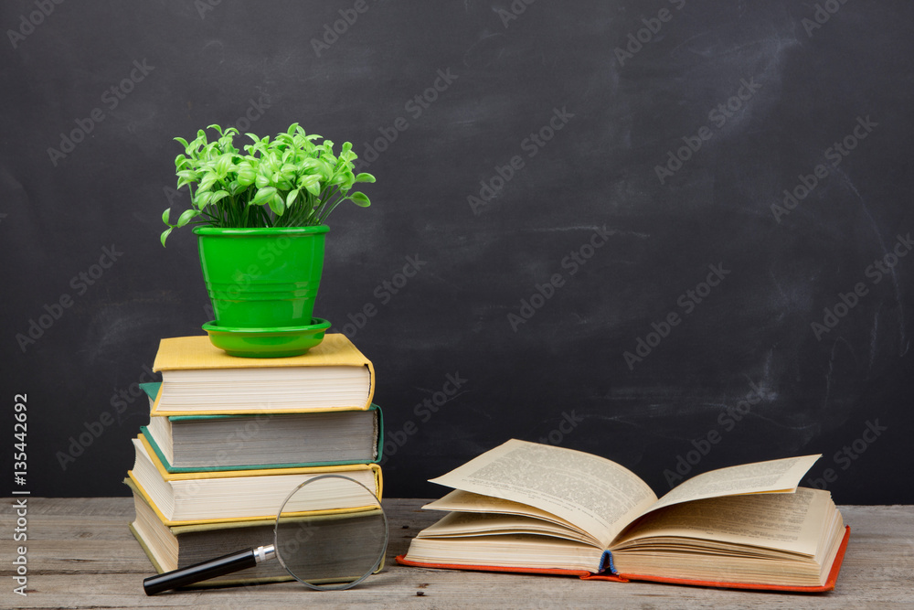 Education concept - books on the desk in the auditorium