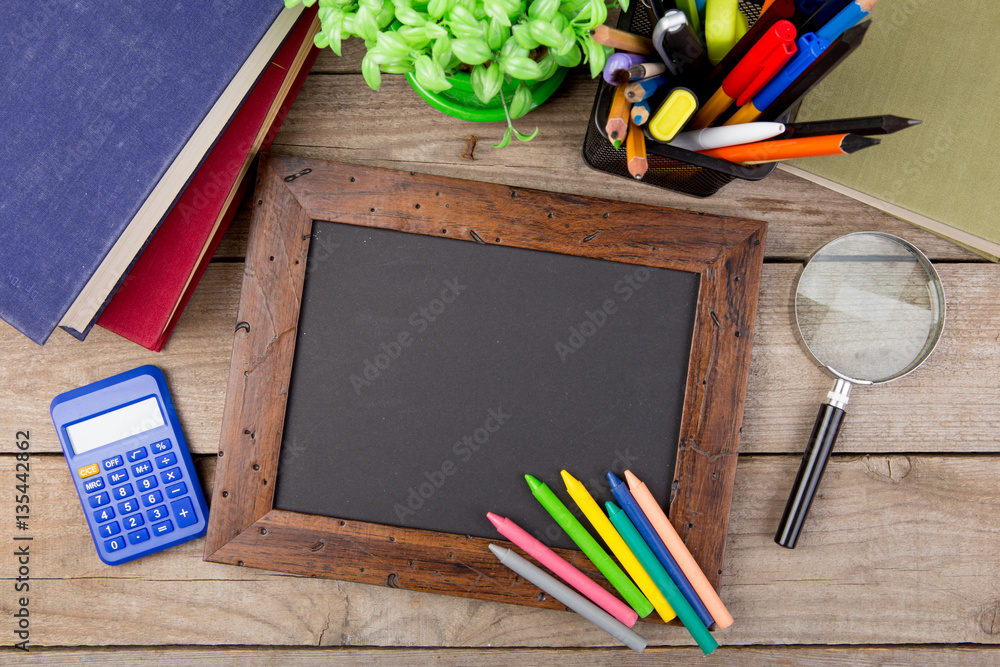 school supplies and blackboard with copy space on table