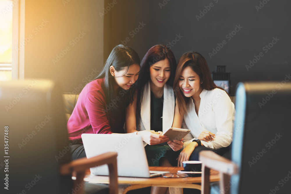 Group of friends meeting in a coffee shop chatting to each other