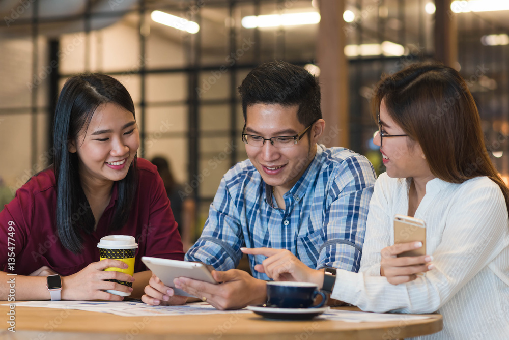 Group of friends meeting in a coffee shop chatting to each other