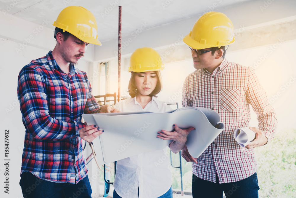 three construction engineers working together in side building p