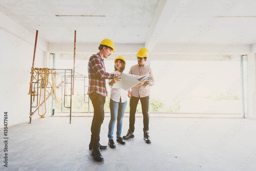 three construction engineers working together in side building p