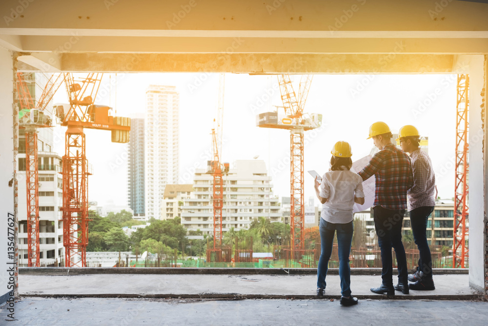 three construction engineers working together in construction si