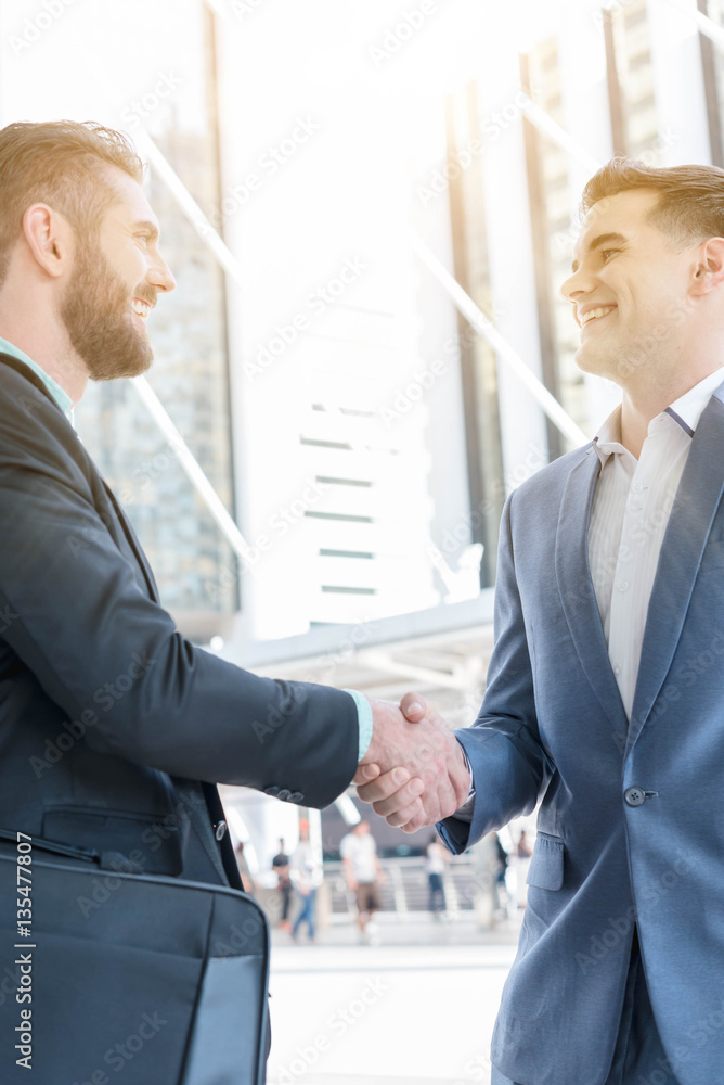 Hand shake of two businessman with sun flare, business conceptua