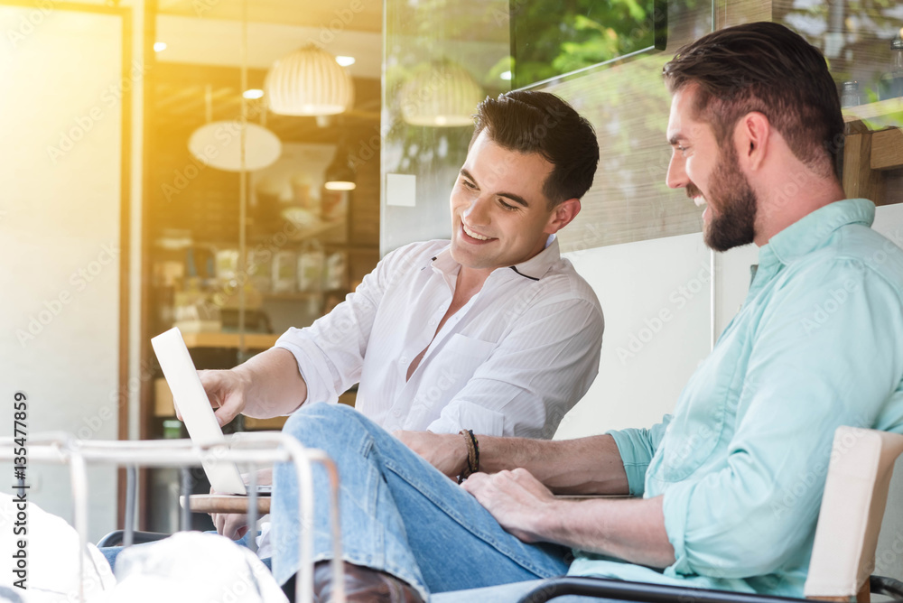 Two Westerner Business men working with laptop and smartphone to