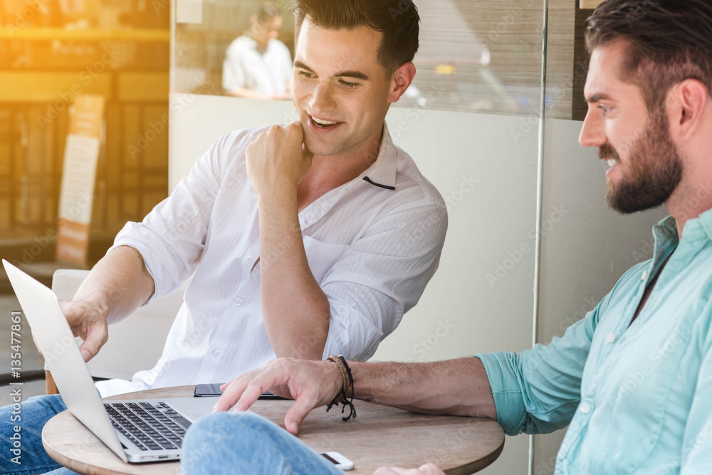 Two Westerner Business men working with laptop and smartphone to