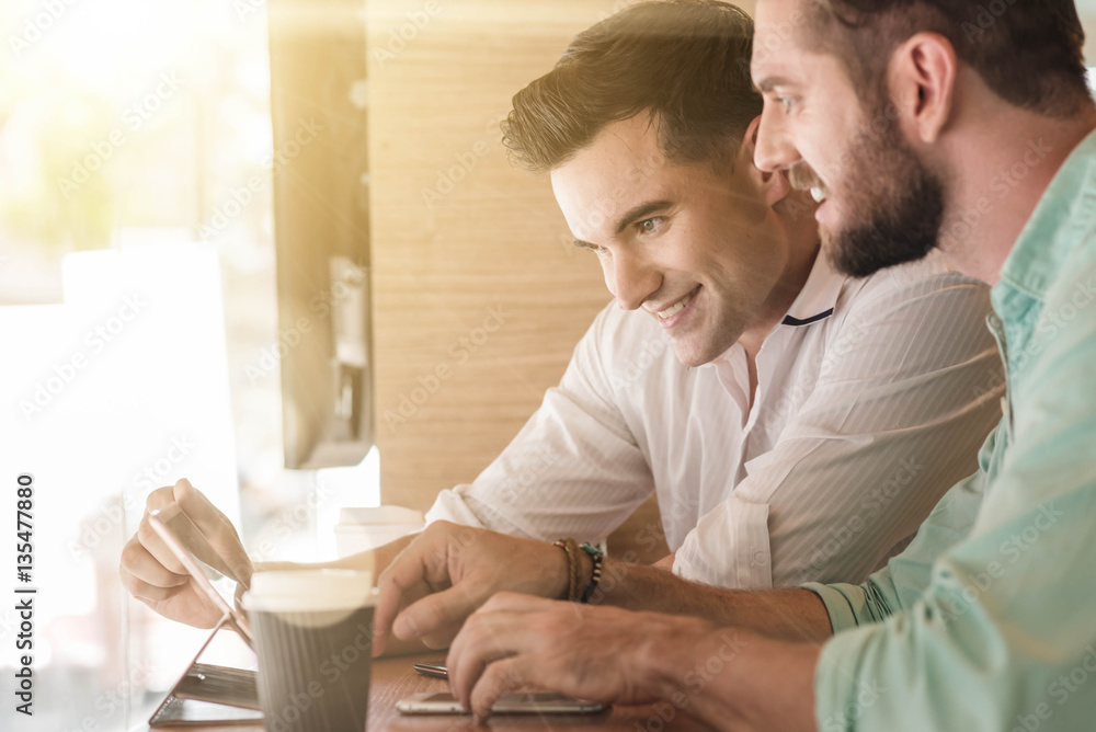 Two Westerner Business men working smartphone and tablet togethe