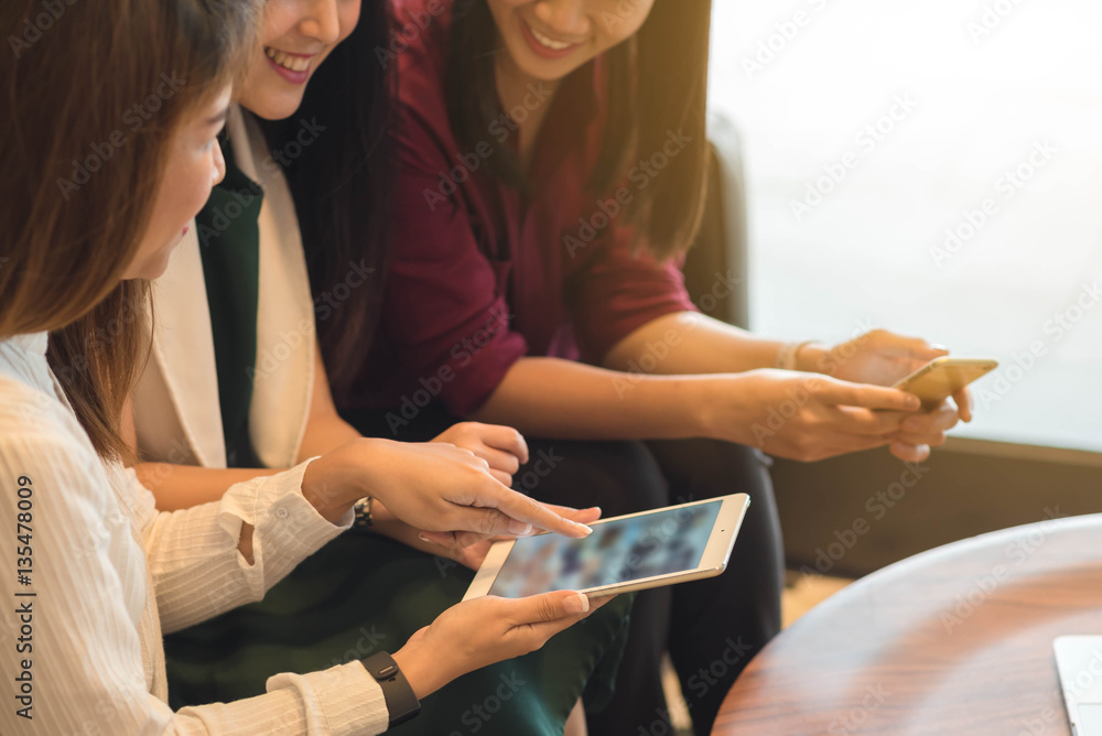 Group of friends meeting in a coffee shop chatting to each other