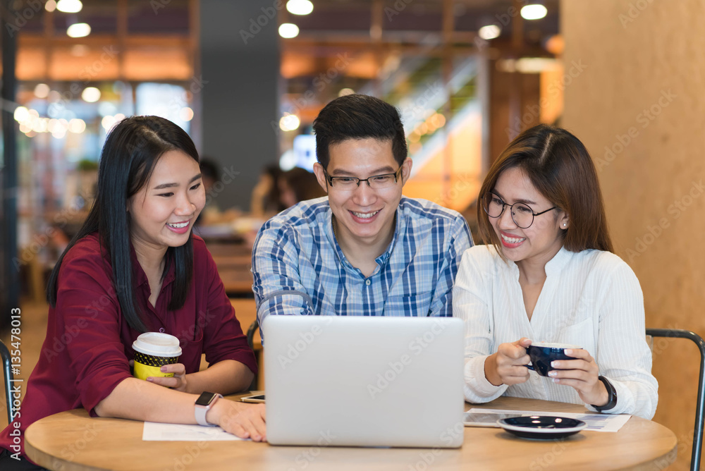 Group of friends meeting in a coffee shop chatting to each other