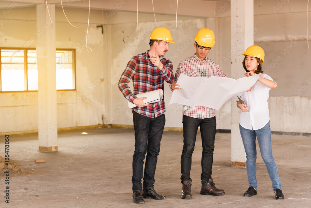 three construction engineers working together in side buiding pl