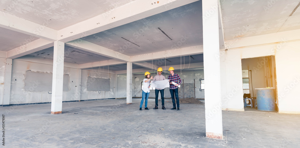 three construction engineers working together in side building p