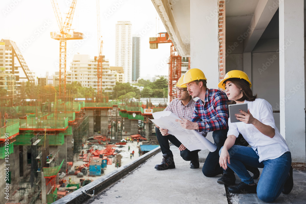 three construction engineers working together in construction si