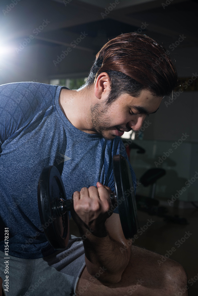 Man lift weight on arm press with studio light shot