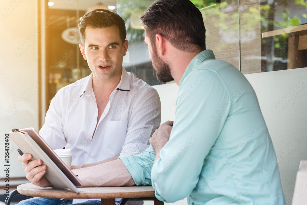 Two Westerner Business men working with laptop, tablet and smart