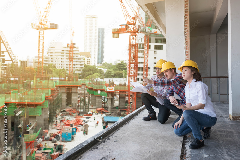 three construction engineers working together in construction si