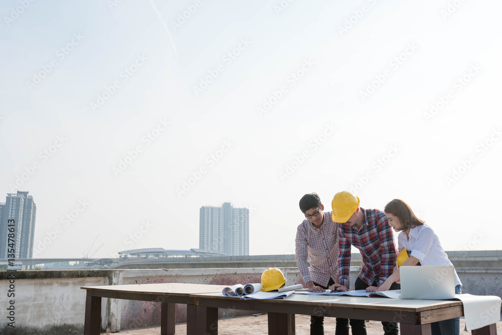 three construction engineers working outdoors in construction si