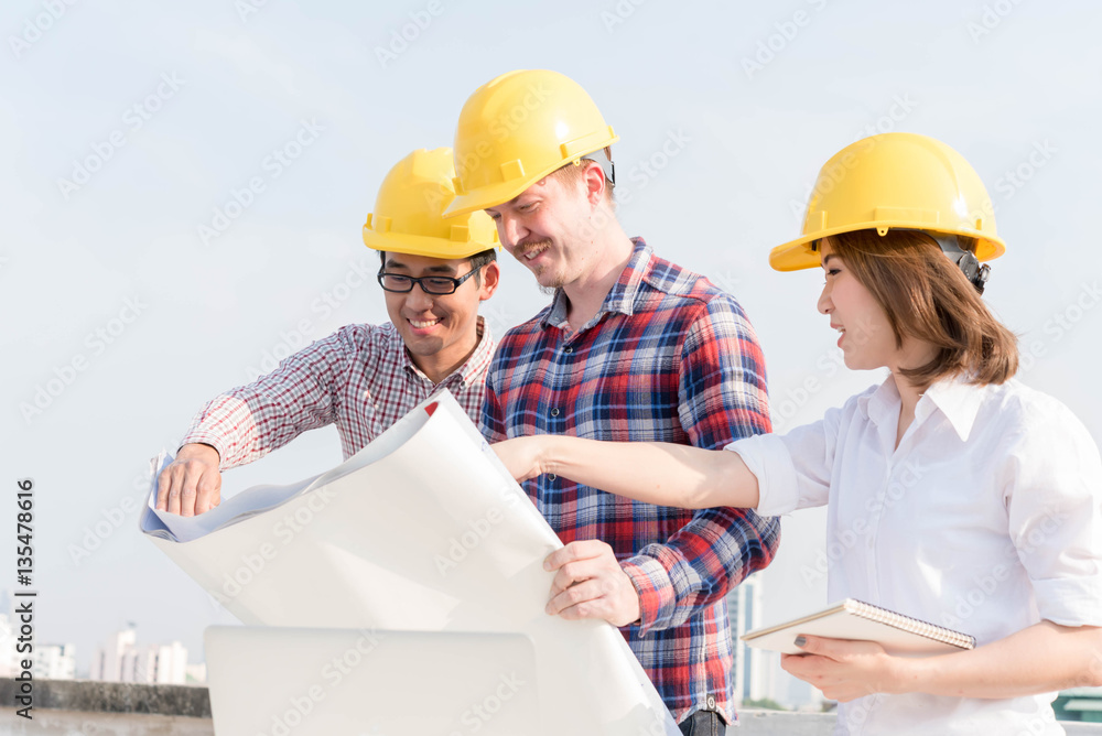 three construction engineers working outdoors in construction si