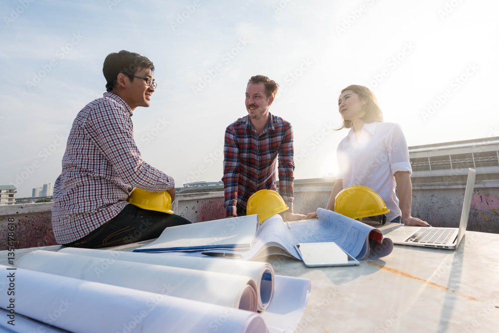 three construction engineers finished working outdoors in constr