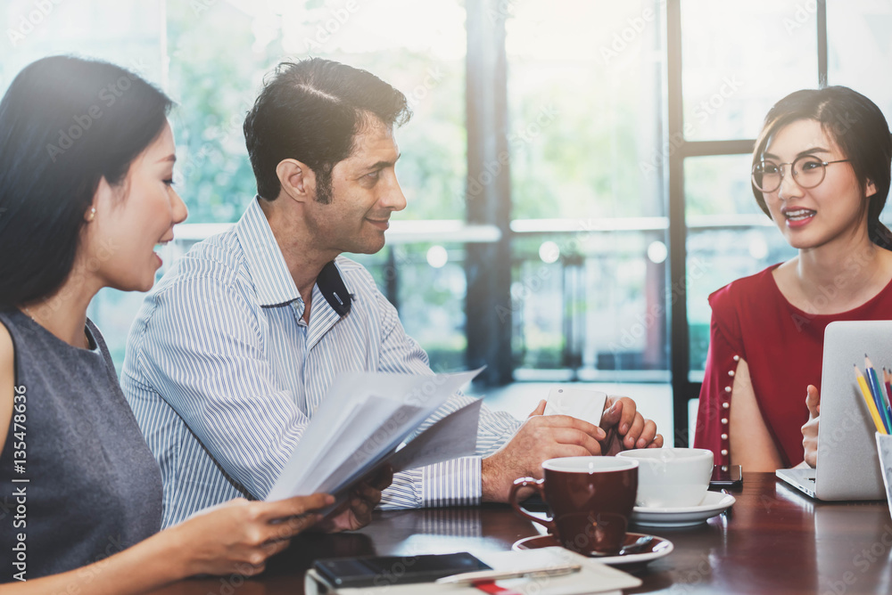 3 people meeting in coffee shop, business casual conceptual