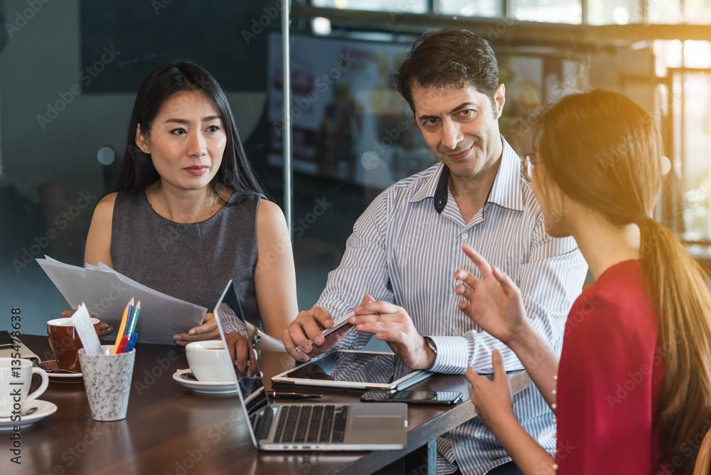 3 people meeting in coffee shop, business casual conceptual