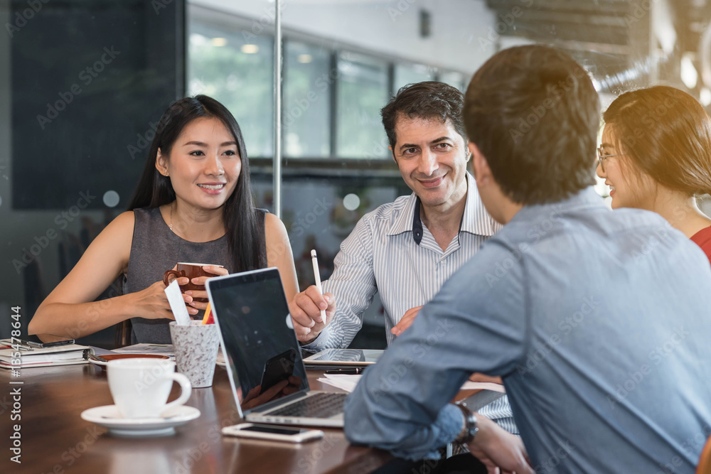 4 people meeting in coffee shop, business casual conceptual