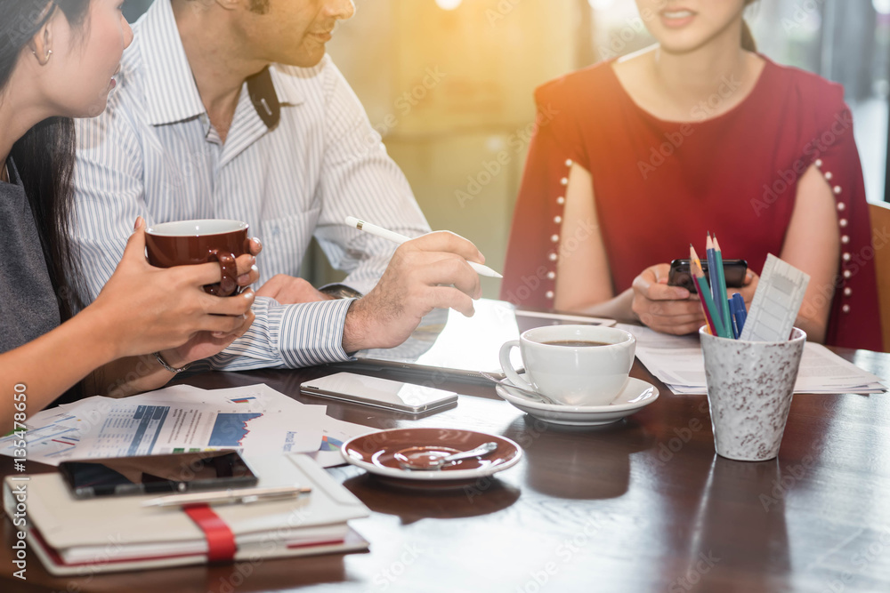 3 people meeting in coffee shop, business casual conceptual