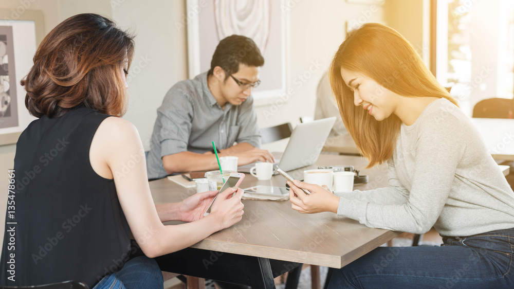 Group of people use technology of laptop smartphone and tablet in coffee shop