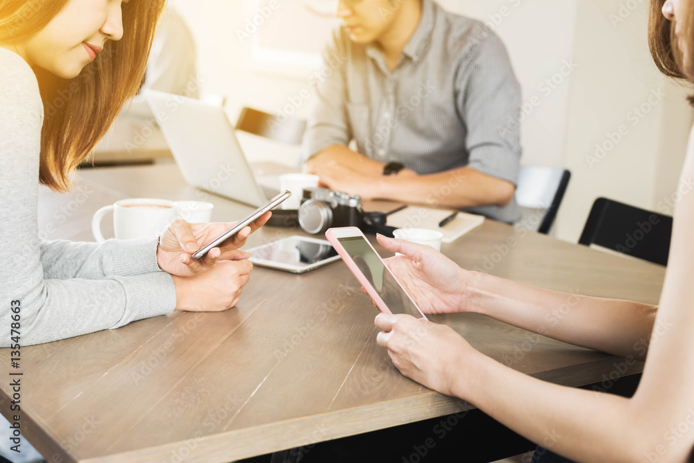 Group of people use technology of laptop smartphone and tablet in coffee shop