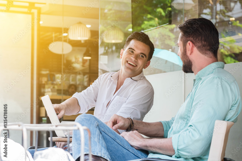 Two Westerner Business men working with laptop and smartphone to