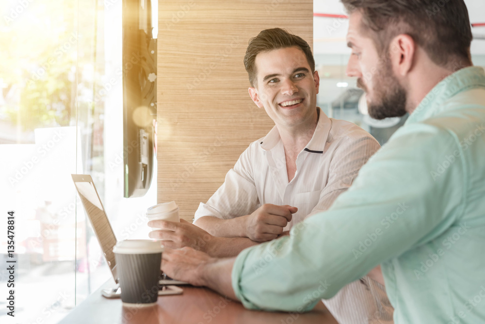 Two Westerner Business men working with laptop, tablet and smart