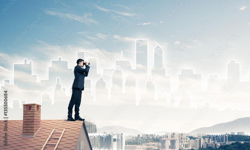 Businessman standing on roof and looking in binoculars. Mixed me