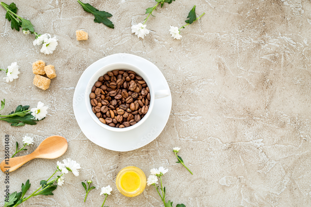 coffee beans on gray with coffe cup table top view