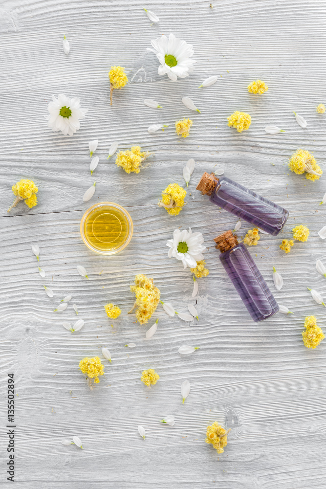 organic cosmetics with camomile on wooden background top view