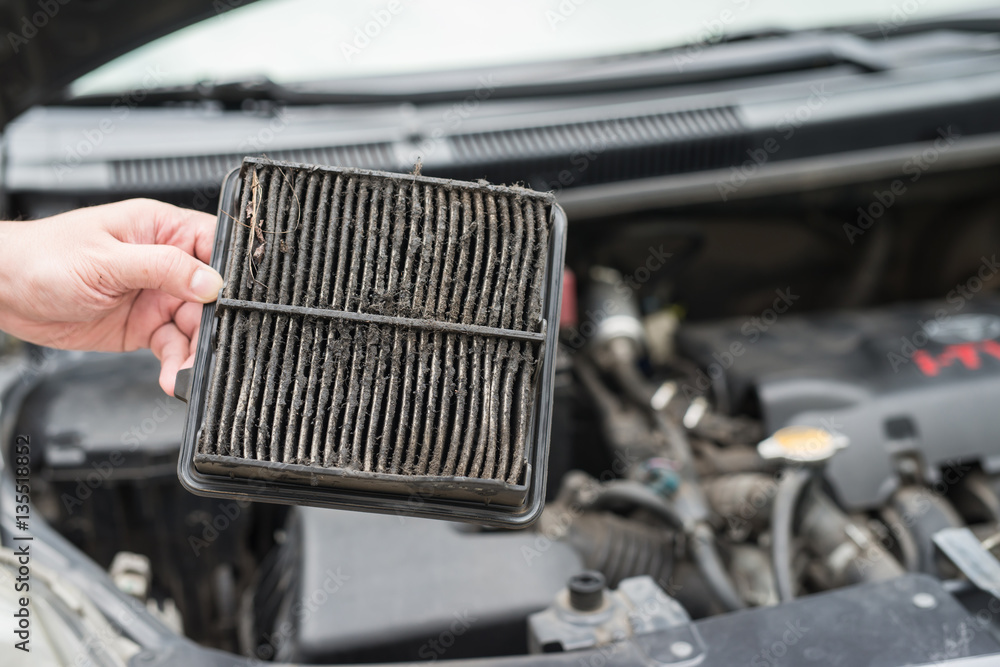 technician holding dirty air filter