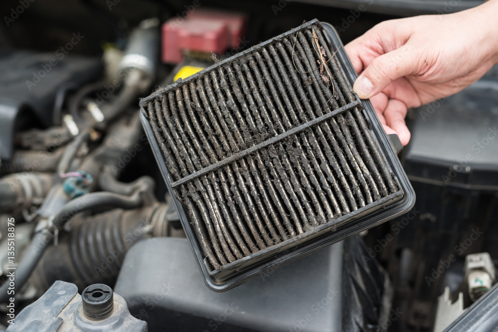 technician holding dirty air filter