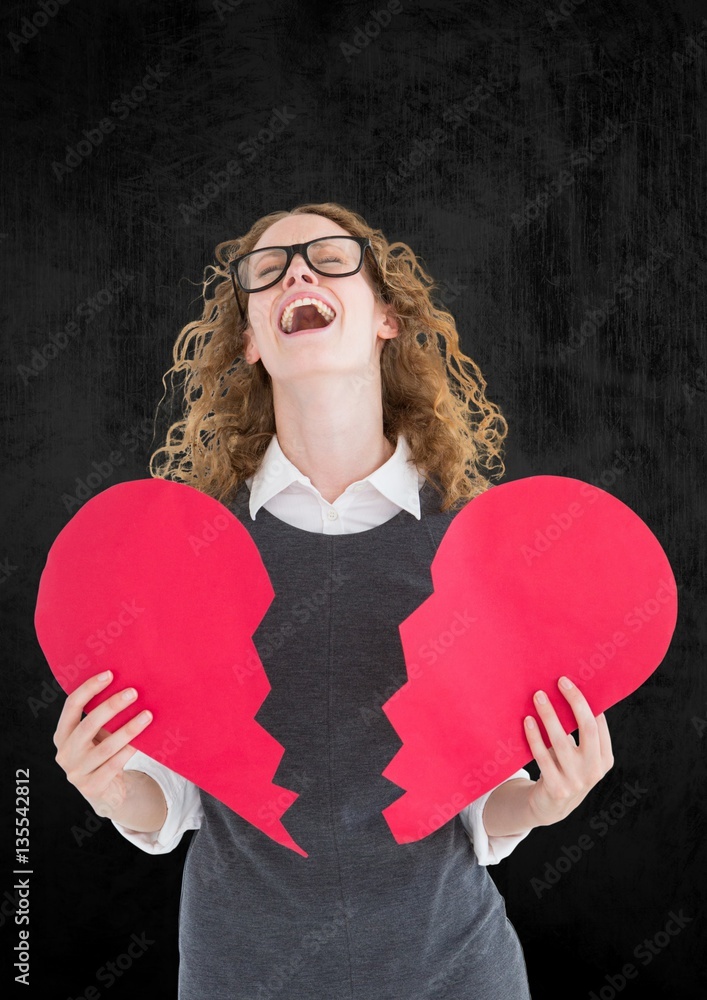 Screaming woman holding broken heart 