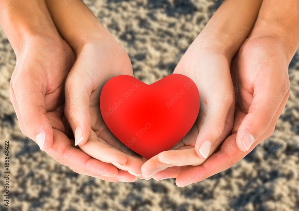 Couple holding heart shape in cupped hands