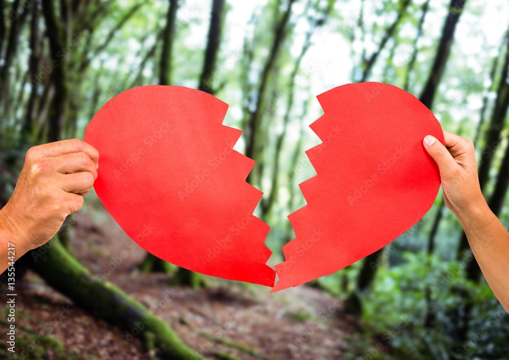 Hands of couple holding broken heart