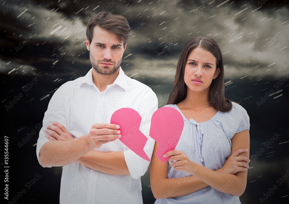 Depressed couple holding broken heart