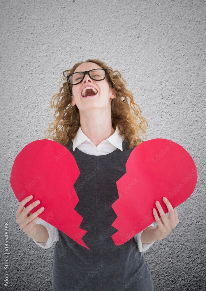 Screaming woman holding broken heart 