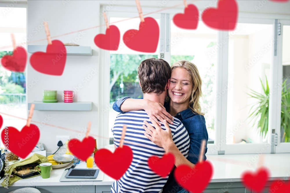 Happy couple embracing each other in kitchen