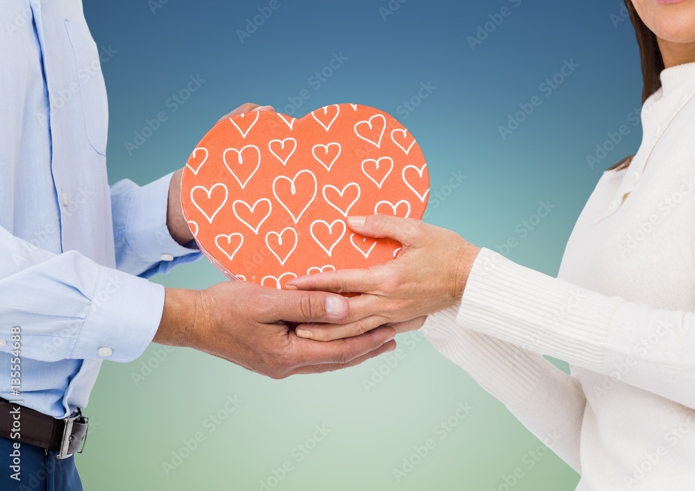 Couple holding heart shape box