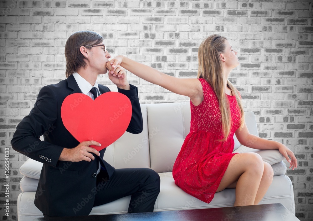 Man holding heart shape kissing on womans hand