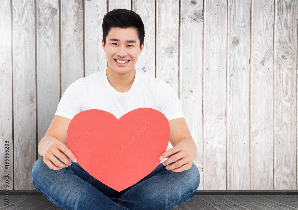 Smiling man holding heart shape