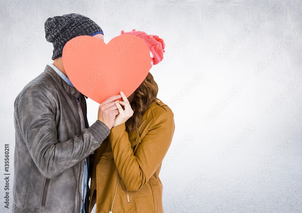 Romantic couple holding heart shape and kissing each other