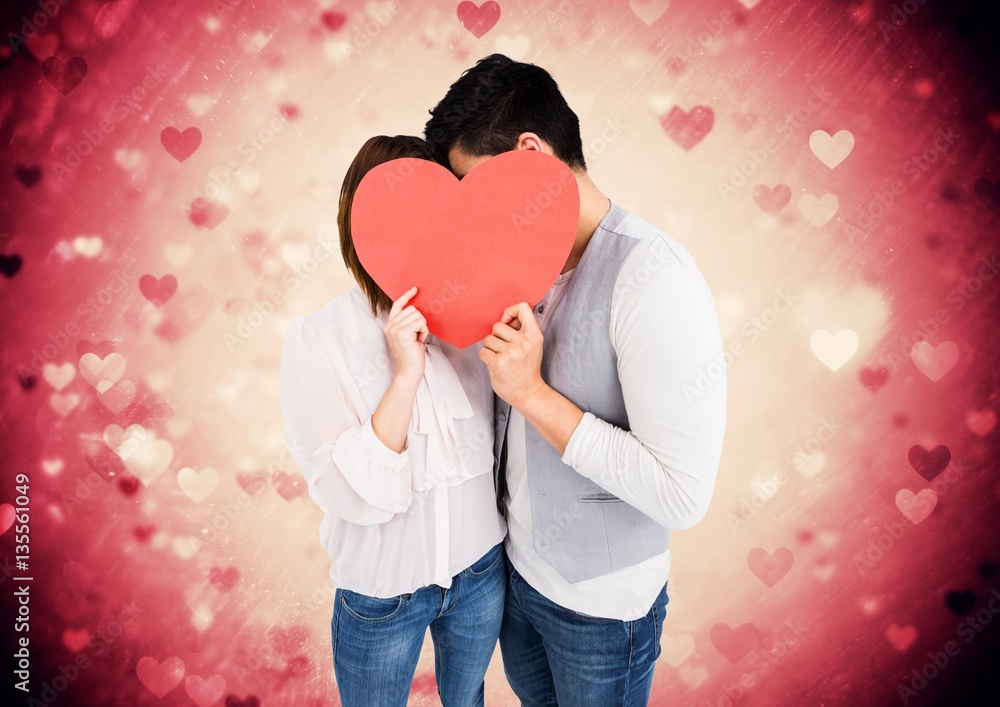 Romantic couple holding heart shape and kissing each other