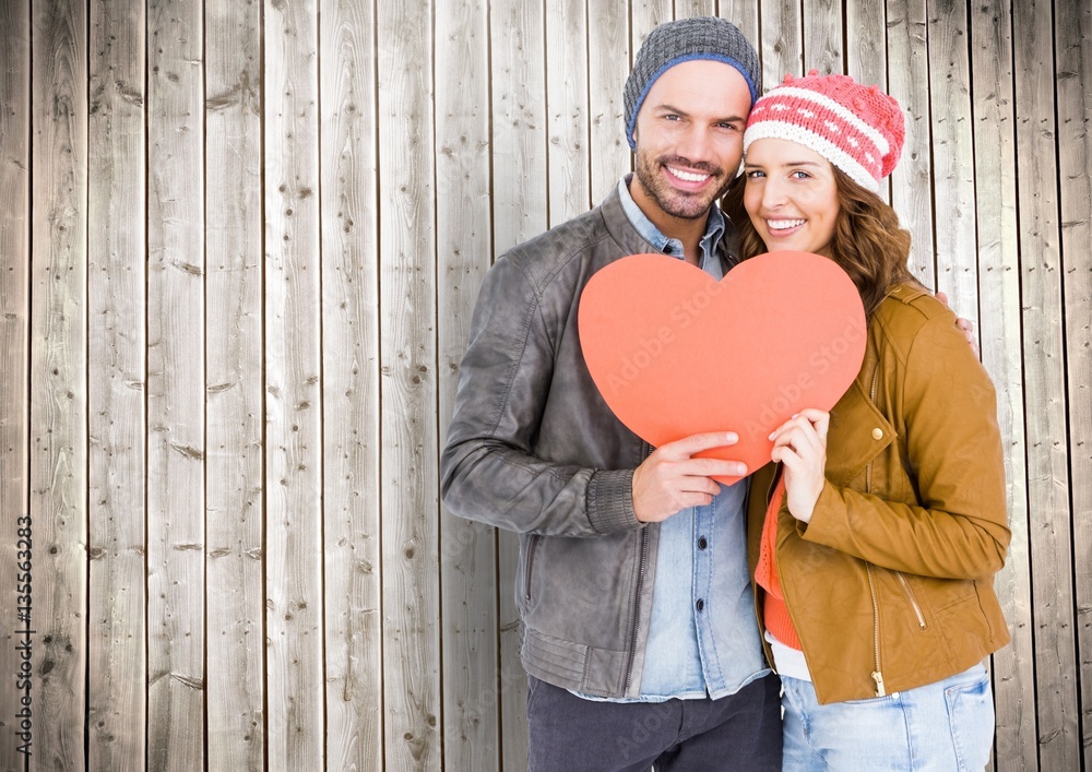 Portrait of happy couple holding a heart shape